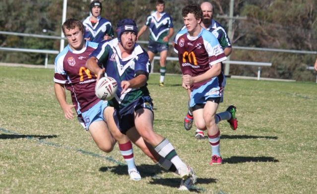 QUICK HANDS: Gremlins player Brad Crisp off loads the ball as his Goondiwindi Maroon opponents move in during their last clash. Photo Contributed QUICK HANDS: Gremlins player Brad Crisp off loads the ball as his Goondiwindi Maroon opponents move in during their last clash. Photo Contributed